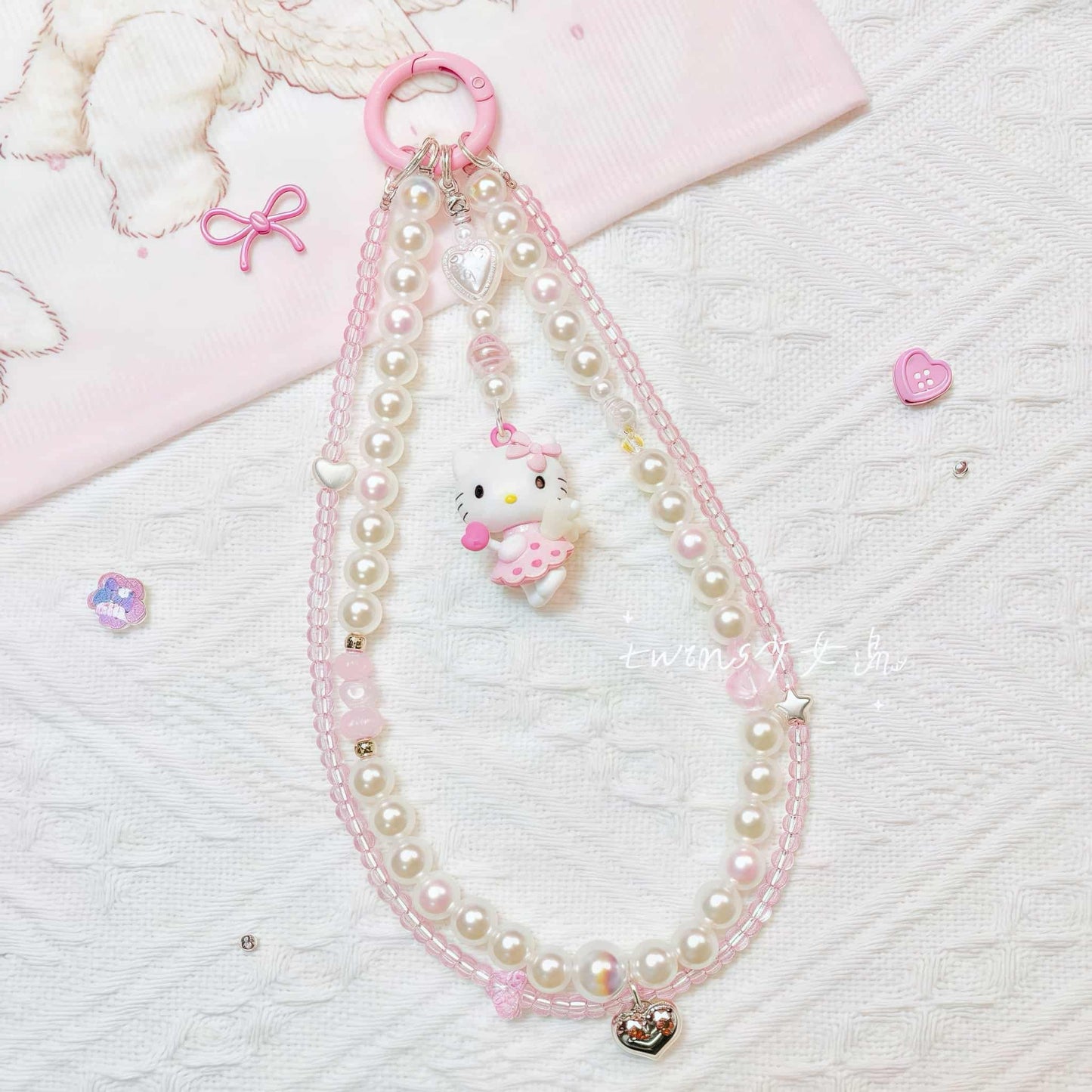 Handmade Hello Kitty phone chain featuring baroque pearls and Sanrio charm pendant