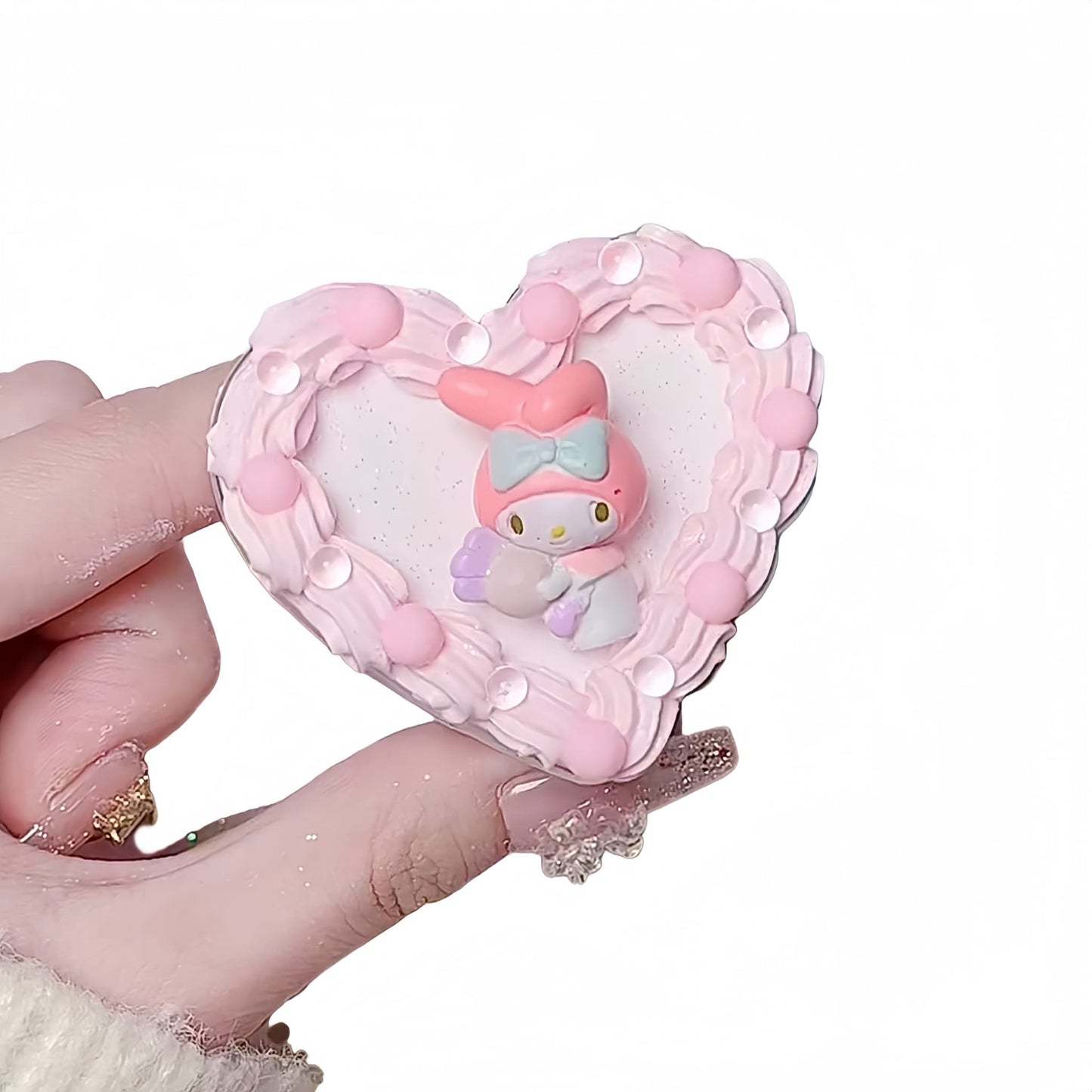 Handmade Y2K My Melody Decoden phone stand with pink and white kawaii charms and pearl embellishments on desktop holder