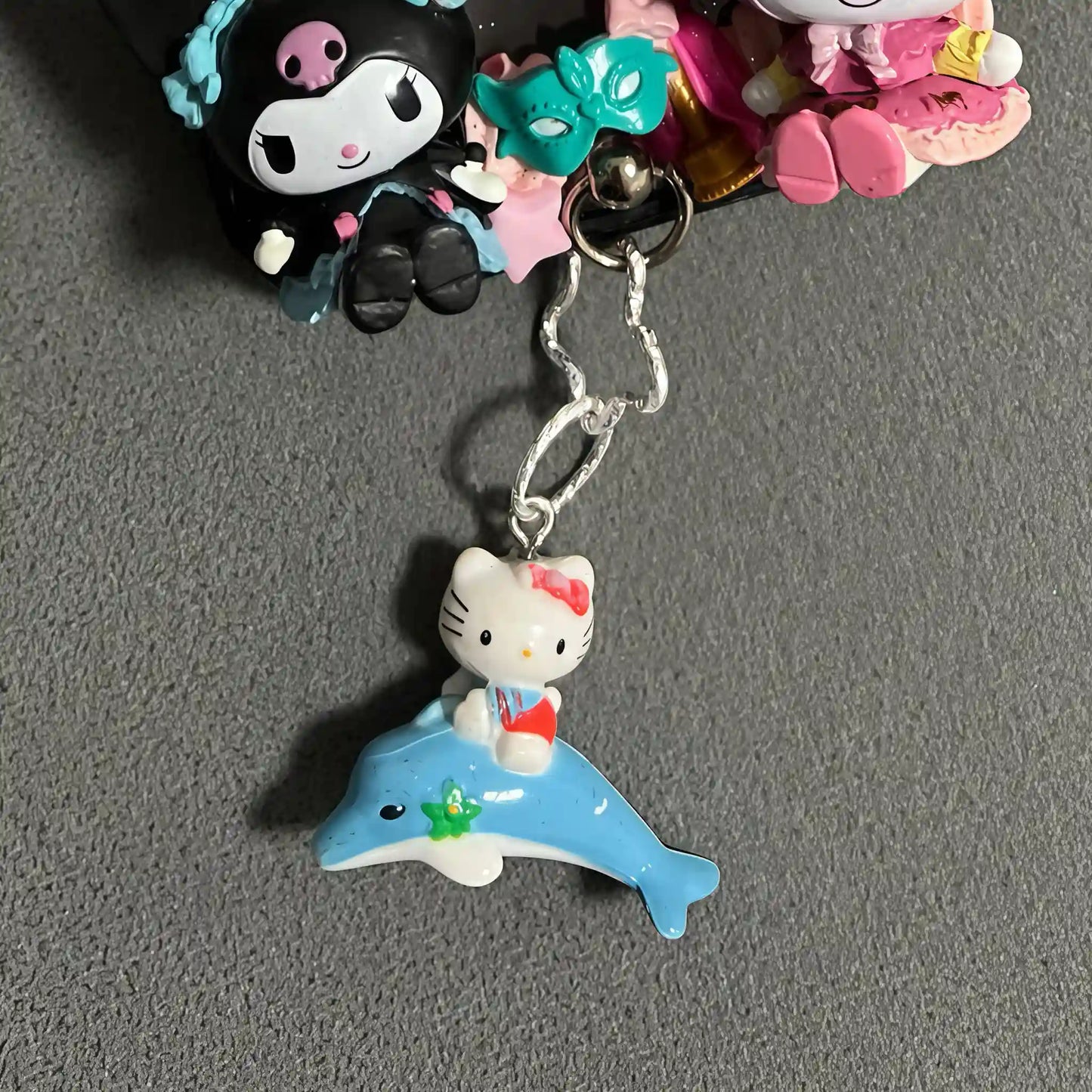 Handmade baroque decoden phone case with Sanrio characters and cream glue embellishments in boutique display