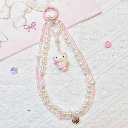 Handmade Hello Kitty phone chain featuring baroque pearls and Sanrio charm pendant
