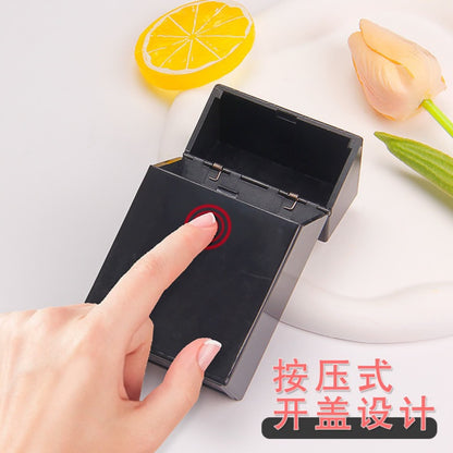 Black compact storage box with press-lid design