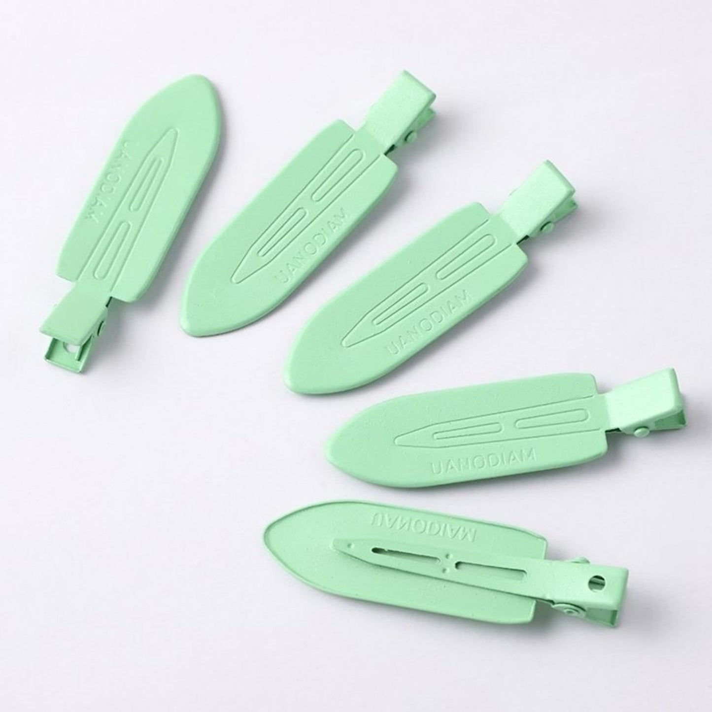 Hair clip base with pearl and rhinestone embellishment showing adhesion quality