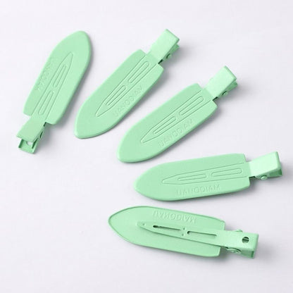 Hair clip base with pearl and rhinestone embellishment showing adhesion quality