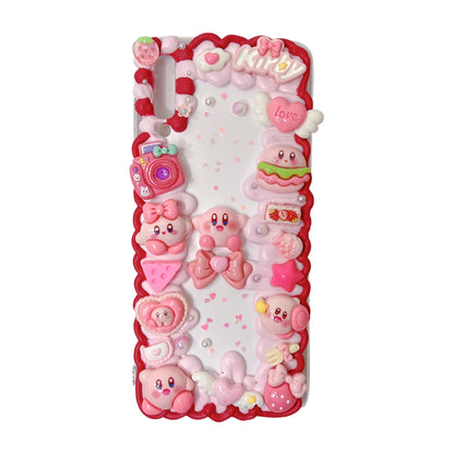 Handmade decoden phone case with custom Kirby design, pink cream glue accents, Baroque Y2K kawaii aesthetic