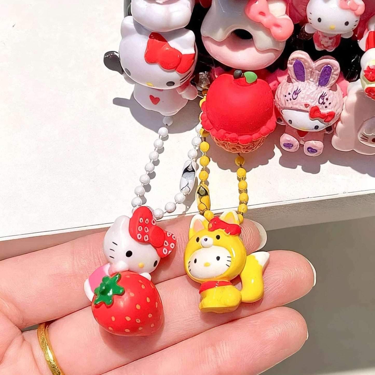 Kawaii Hello Kitty phone charm accessory with handmade decoden decorations and beads