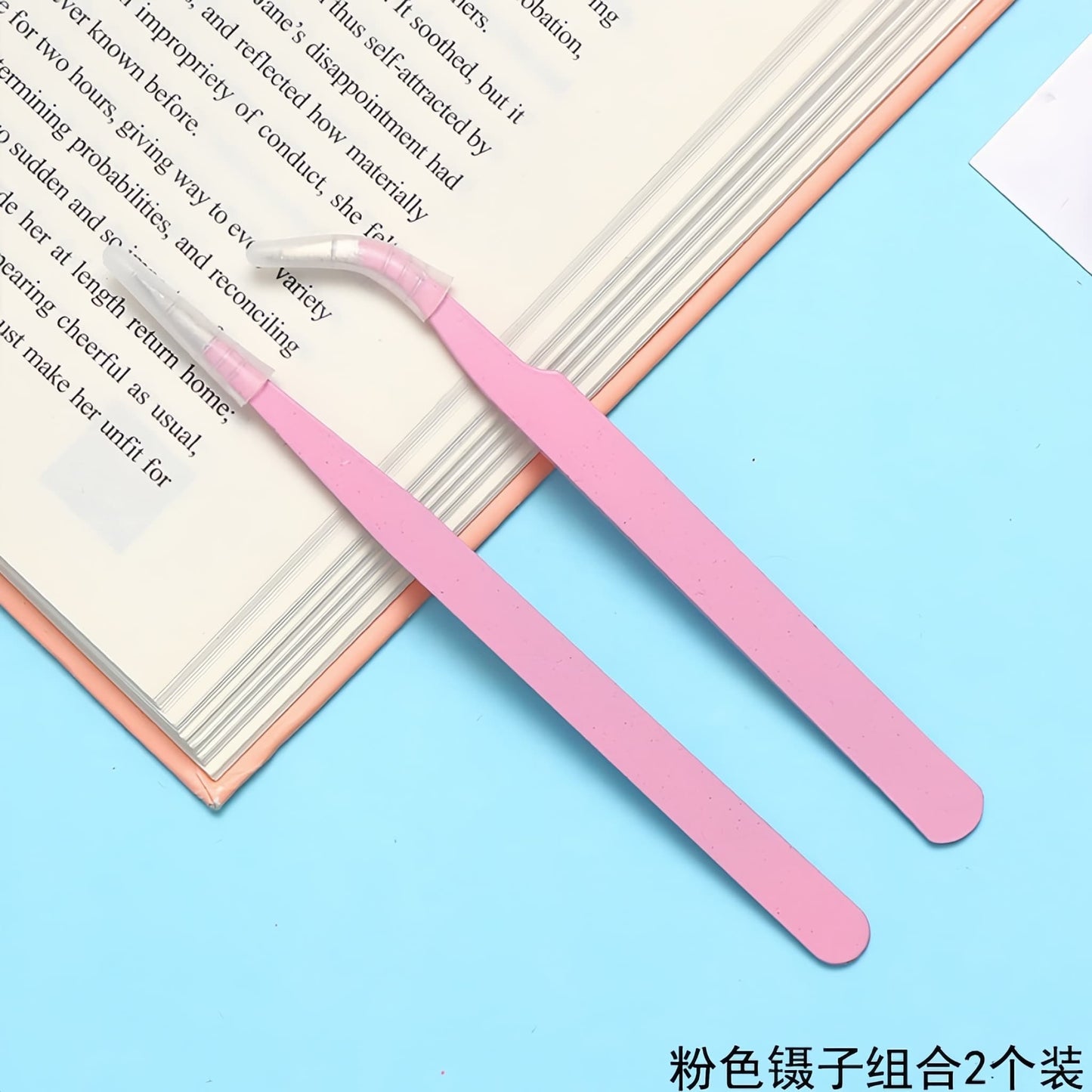 Close-up of curved tip tweezers picking up rhinestone for phone case decoration