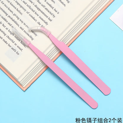 Close-up of curved tip tweezers picking up rhinestone for phone case decoration