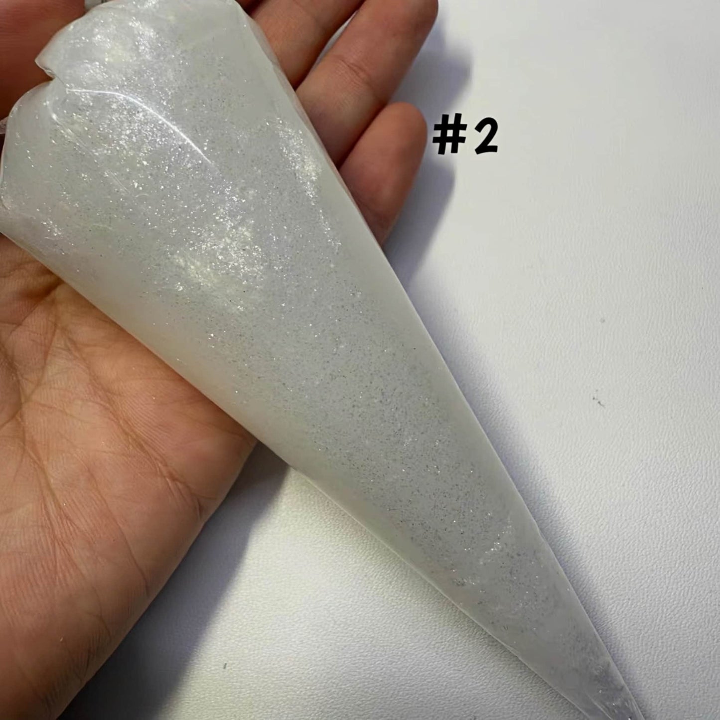 White shimmer cream adhesive with piping tip for kawaii DIY crafts and 3D decorations