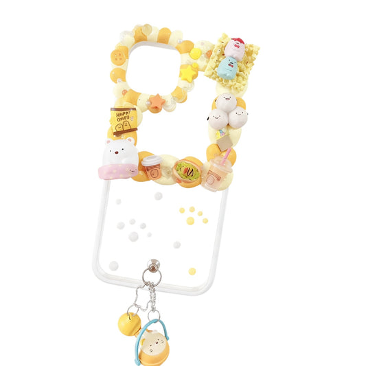 Handmade yellow decoden phone case featuring Sumikko Gurashi characters with cream glue design, baroque embellishments and kawaii Y2K aesthetic
